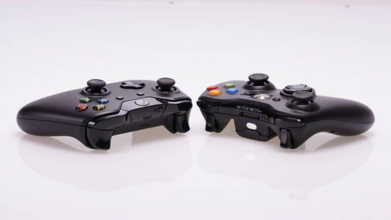 two xbox controllers facing each other