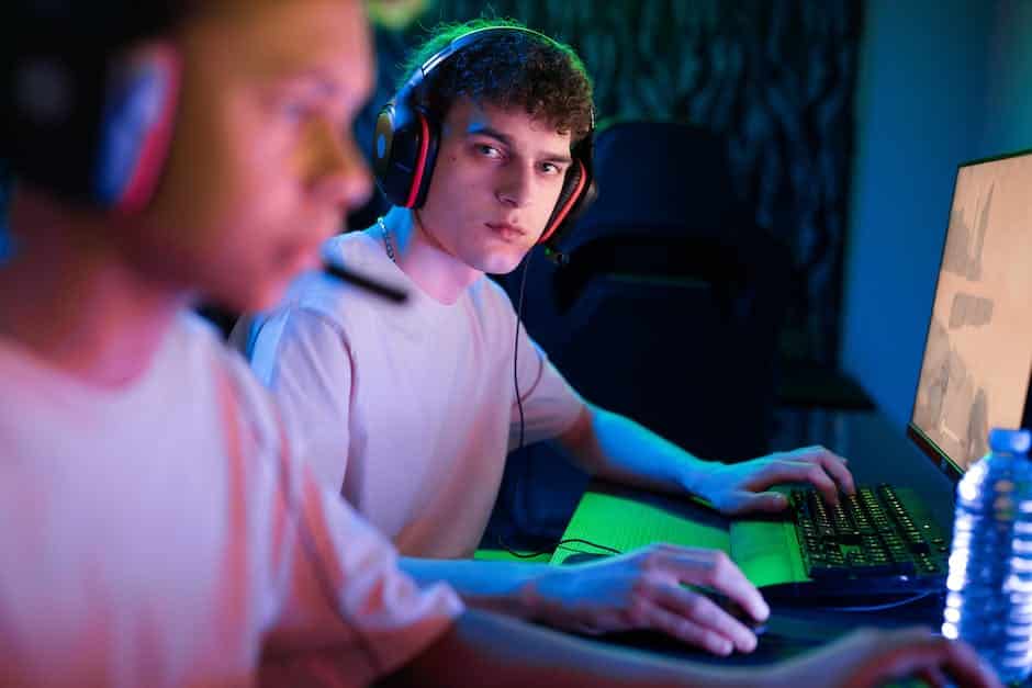 A person wearing a gaming headset with a laptop in the background.